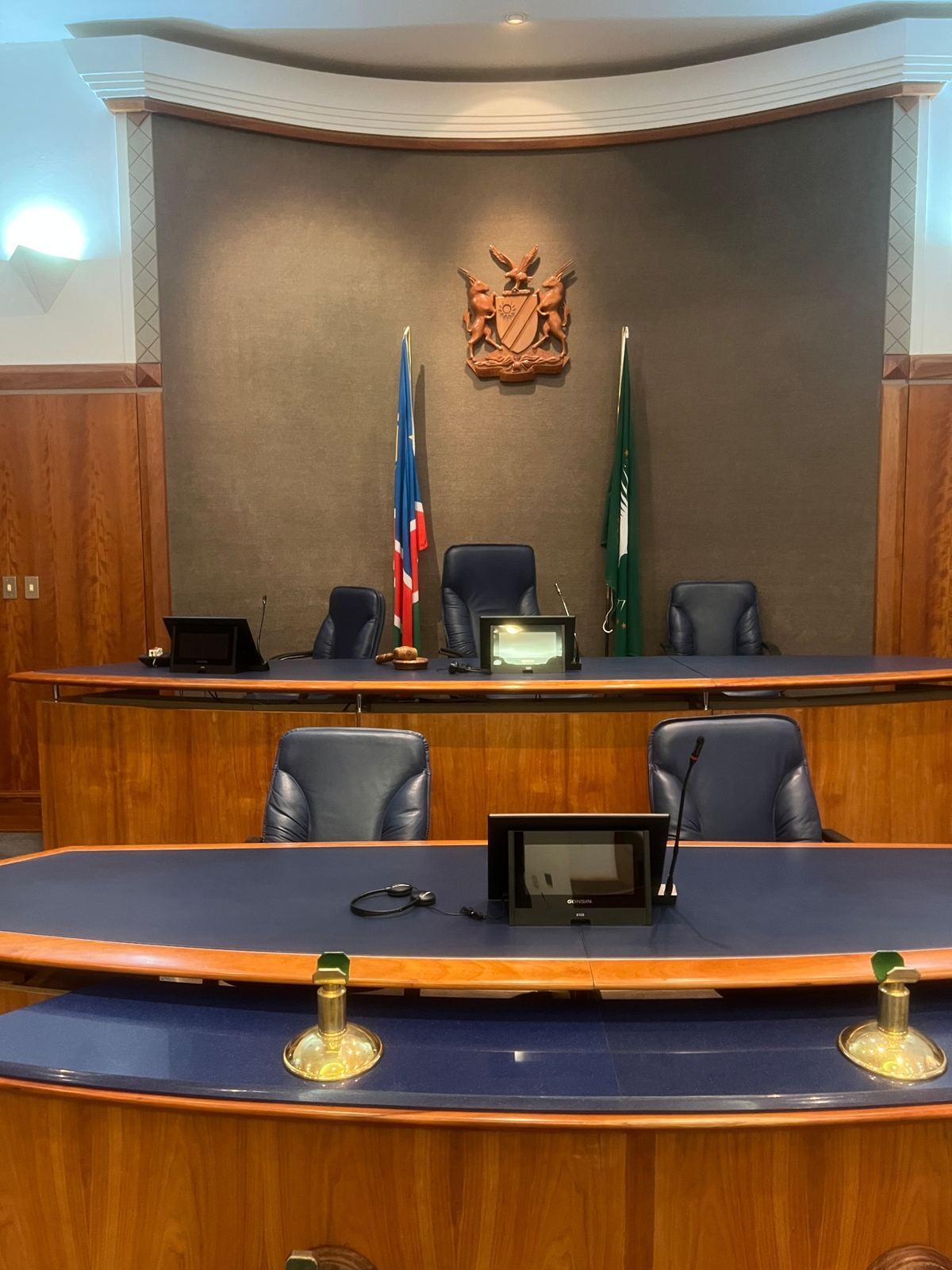 Head table of the National Council Chamber with integrated conference units and national flags